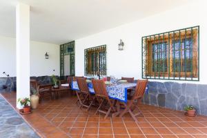 a dining room with a table and chairs and stained glass windows at Finca La Vizcondesa in Icod de los Vinos