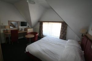מיטה או מיטות בחדר ב-Hotel Duinzicht
