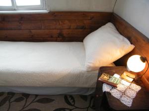 a bedroom with a bed and a table with a lamp at Rainmühle in Mariánské Lázně