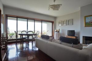 a living room with a couch and a table at sunset@leçadapalmeira in Matosinhos