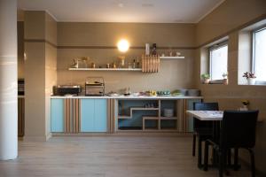 a kitchen with a counter and a table in a room at Hotel Atrium in Târgu Secuiesc
