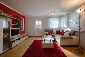 a living room with a couch and a tv at Ferienhaus Martina in Bad Brambach