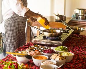 a chef preparing food on a table in a kitchen at Talalla Retreat in Talalla South