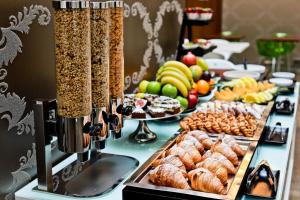 a buffet of food on a table with food at Friday Hotel in Prague +18 photos