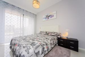 a bedroom with a bed and a dresser and a window at Penthouse 2 bedrooms in Mil Palmeras in Pilar de la Horadada