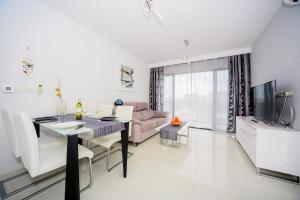 a living room with a dining table and a couch at Penthouse 2 bedrooms in Mil Palmeras in Pilar de la Horadada