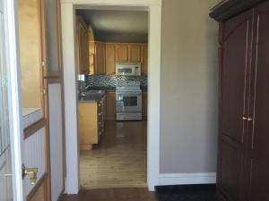 a kitchen with wooden cabinets and a white stove at The Coastal Country House in New Brunswick in Cape Tormentine +58 photos