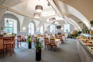 a restaurant with tables and chairs and a buffet at JUFA Hotel Seckau - Self Check-in in Seckau