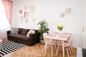 a living room with a table and a couch at Twin Apartment in Vienna