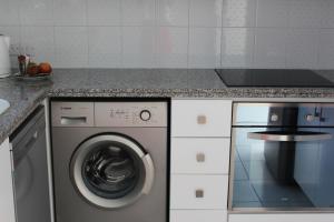 a kitchen with a washing machine and a counter at Olosuites in Limassol