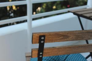 a close up of a wooden bench in front of a window at Olosuites in Limassol
