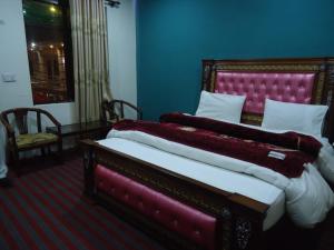 A bed or beds in a room at Hotel Mountain Track - Taranna Balakot