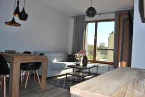 a living room with a couch and a table at Ambar Apartament in Gdańsk