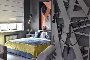 a bedroom with a king sized bed and a chair at MaNNa Boutique Hotel in Kyiv