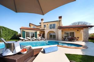a villa with a swimming pool and a house at Luxury Villa S Domenica near Poreč with Pool, Wine Cellar and Billiard in Labinci