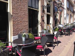 a row of tables and chairs on a street at Studio's de Domburger in Domburg