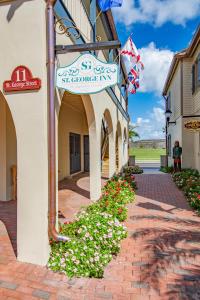 a sign on the side of a building with flowers at St George Inn - Saint Augustine in St. Augustine