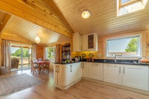 a kitchen with wooden walls and a wooden ceiling at The Lodge in Stowmarket
