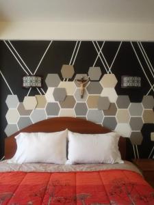 a bedroom with a bed with a black and white wall at Hotel "VIRGEN DEL SOCAVON" in Oruro