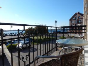 a balcony with a table and a view of a parking lot at Hamnhotellet Kronan in Landskrona