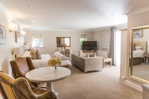 a living room with a couch and a table at Cricket Field House in Salisbury