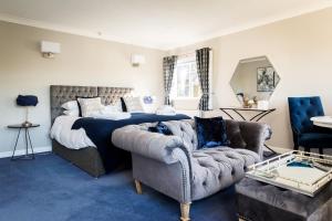 a bedroom with a bed and a couch at Cricket Field House in Salisbury