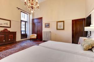 Postel nebo postele na pokoji v ubytování Palazzo Pisani