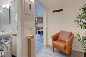 an orange chair in a bathroom with a sink at Sleep Tight Florence Apartment in Florence +220 photos