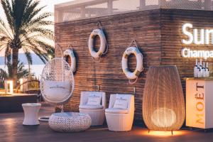 a white toilet sitting next to a wooden wall at Iberostar Selection Playa de Palma in Playa de Palma