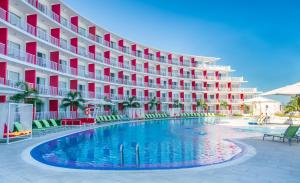 a hotel with a swimming pool in front of a building at Royal Decameron Cornwall Beach - All Inclusive in Montego Bay
