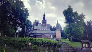 a large building with a clock tower in a park at Hahnenklee Ferienpark 1-411 in Hahnenklee-Bockswiese