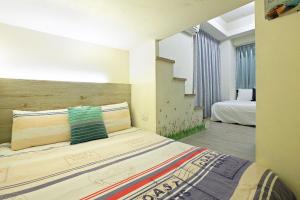 a bedroom with a large bed and a staircase at Funny Stay in Taichung