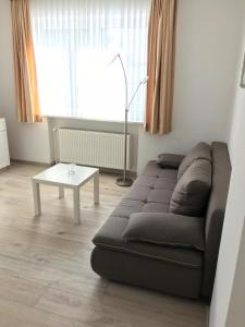 a living room with a couch and a table at Hotel Esinger Hof garni in Tornesch