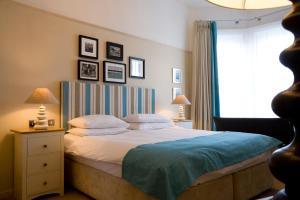 A bed or beds in a room at The Old Custom House 