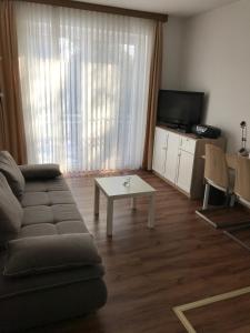 a living room with a couch and a table at Hotel Esinger Hof garni in Tornesch