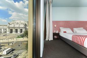 
a hotel room with a bed and a window at Glam Milano in Milan
