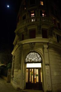 a tall building with an entry door at night at Ostello Domus Civica in Venice