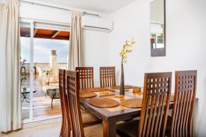 - une salle à manger avec une table et des chaises en bois dans l'établissement Tropical penthouse, à Rincón de la Victoria