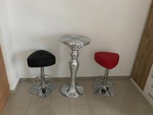 three bar stools sitting on a tile floor at Gästehaus Blümel in Köflach