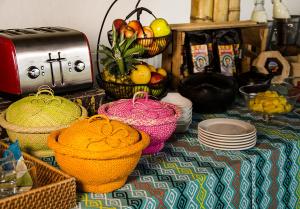 a table with baskets of fruit and plates on it at Hacienda Bambusa in El Caimo