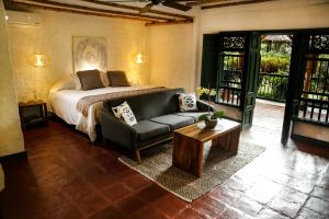 מיטה או מיטות בחדר ב-Hacienda Bambusa