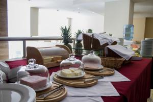 a table with plates and dishes on a red table cloth at Central Park Hotel & Casino in Panama City