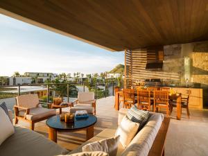 a living room with a couch and a table at Chileno Bay Resort & Residences, Auberge Resorts Collection in Cabo San Lucas