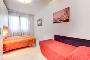 a hotel room with two beds and a window at Priuli Canal View in Venice