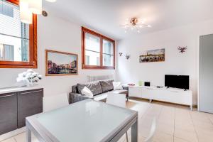 a living room with a couch and a tv at Priuli Canal View in Venice