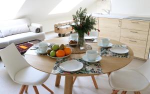 a dining room table with a bowl of fruit on it at Apartamentos Plaza Mayor in Gijón
