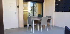 a dining room table and chairs in a house at Torre de la horadada Alicante in Torre de la Horadada