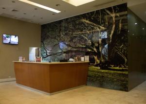 a lobby with a large mural of trees on the wall at Central Park Hotel & Casino in Panama City