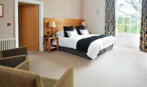 a bedroom with a large bed and a window at St Elizabeth's House in Plymouth