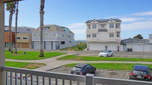 a balcony with two cars parked in a parking lot at Ocean Surf Inn & Suites in Huntington Beach